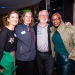 Four Member Party attendees posing for camera