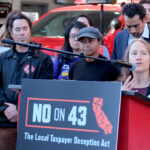 Executive Director Amie Fishman speaking at podium