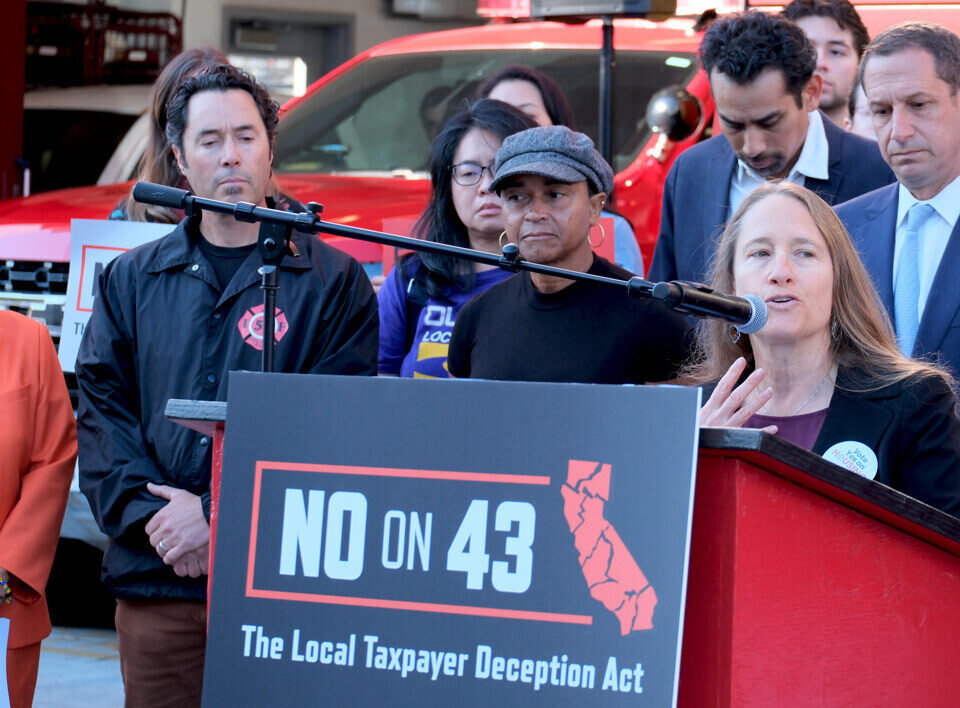 Executive Director Amie Fishman speaking at podium