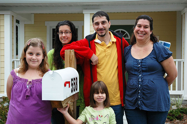 Photo of family near a mailbox