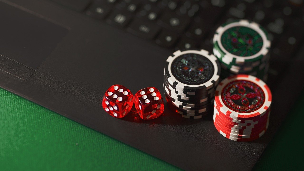 Poker chips and dice on a laptop