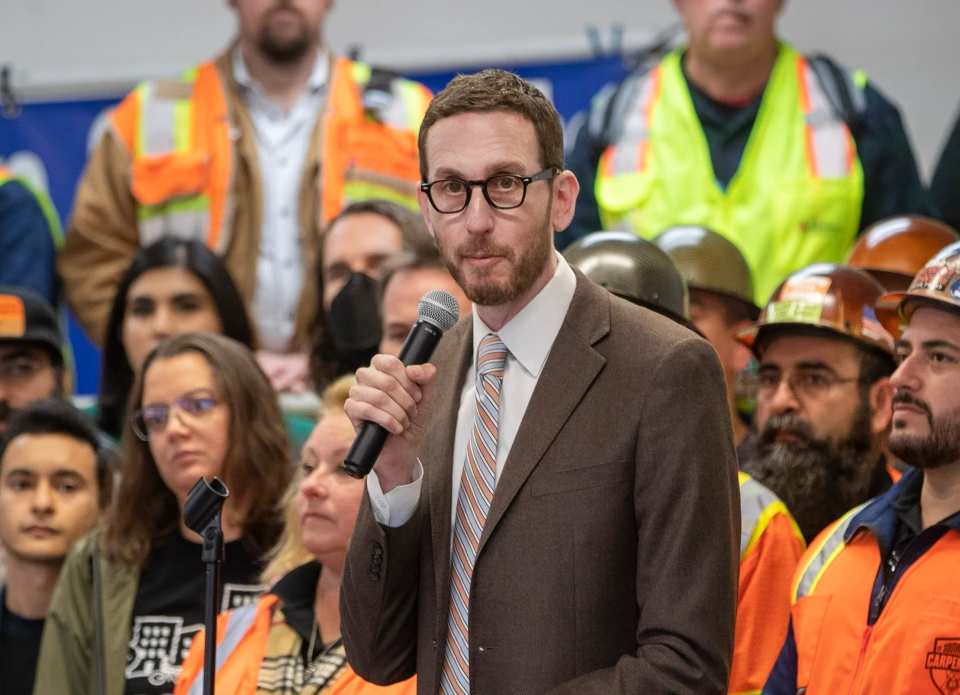Scott Wiener speaking in front of trades council to a crowd off-camera.
