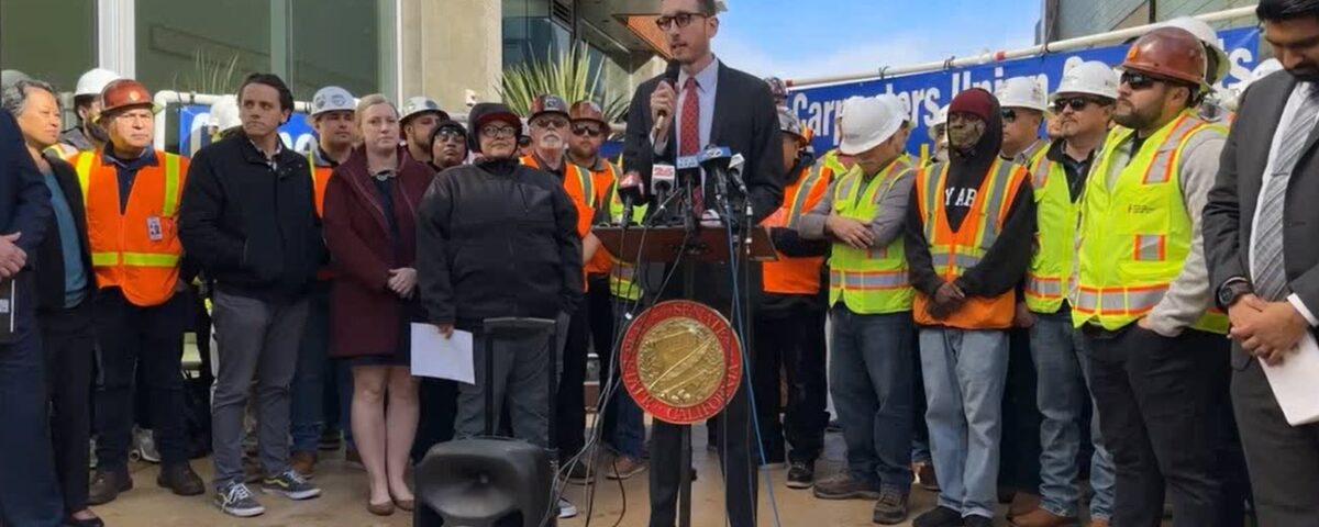 Scott Wiener talking in front of workers