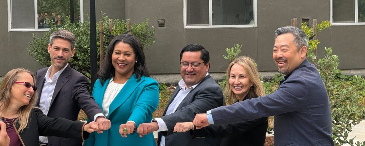 Mayors of major bay area cities and Amie putting hands together for photo