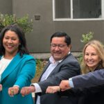 Mayors of major bay area cities and Amie putting hands together for photo