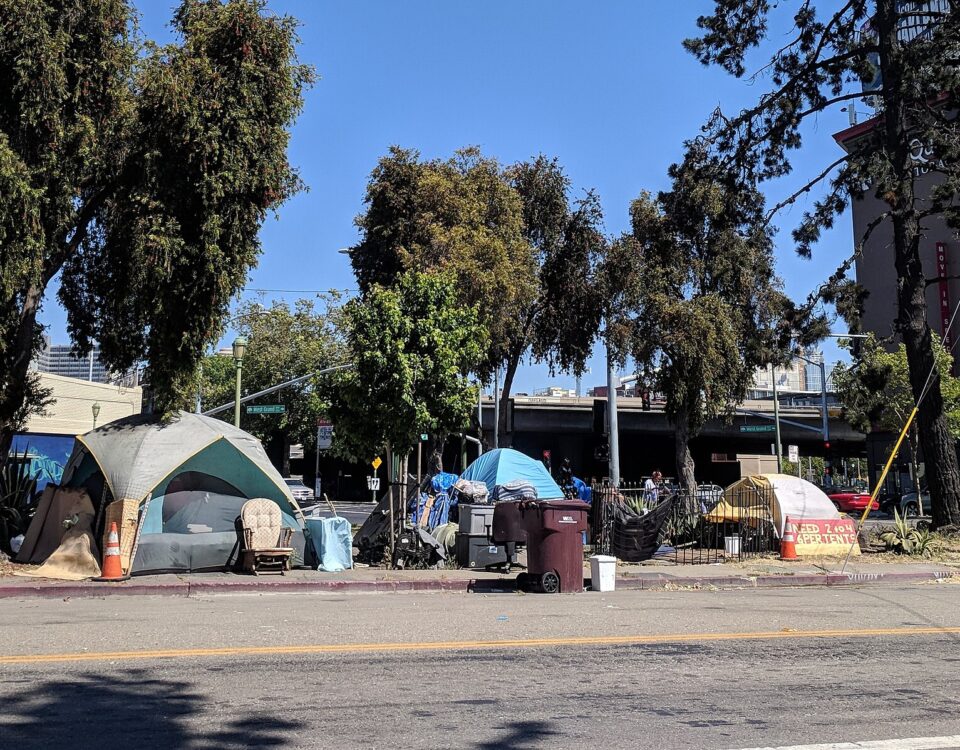 Tents on the sidewalk in an Oakland neighborhood