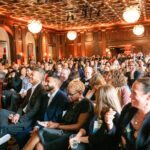 Attendees at Leadership awards smiling towards the stage