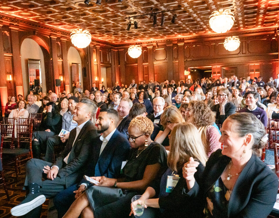 Attendees at Leadership awards smiling towards the stage