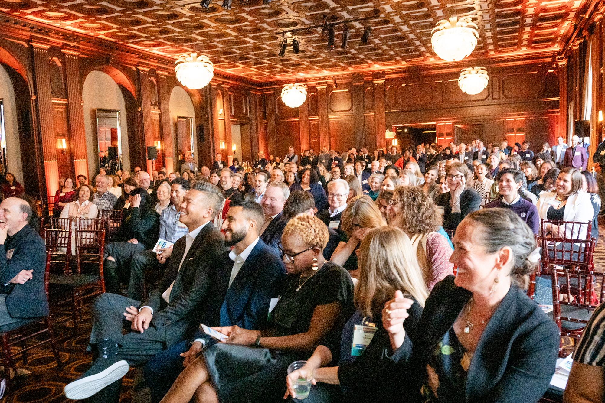 Attendees at Leadership awards smiling towards the stage